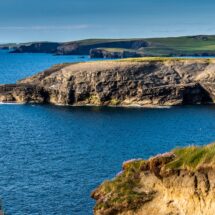 Scenic coastal view with rugged cliffs and blue sea, perfect for nature lovers. Enjoy stunning landscapes near our hotel.