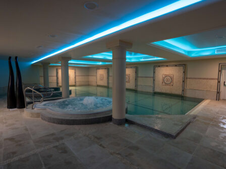 Luxurious indoor hotel spa with bubbling hot tub, elegant decor, and ambient lighting for ultimate relaxation and comfort.