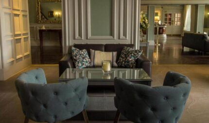 Elegant hotel lobby with plush seating, soft lighting, and decorative accents, inviting guests to relax in luxury.