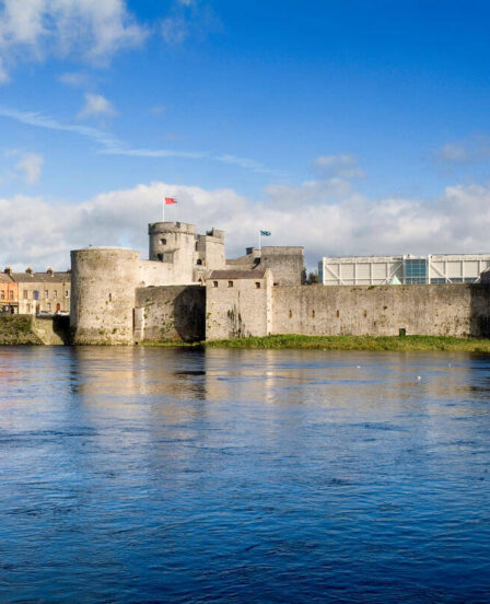 Riverside view of historic castle, vibrant sky, and lush grounds offering an elegant, cultural retreat near city centre.