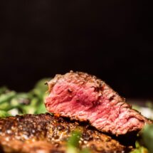 Savour a succulent steak cooked to perfection, nestled on a bed of fresh greens at our luxury hotel's gourmet restaurant.