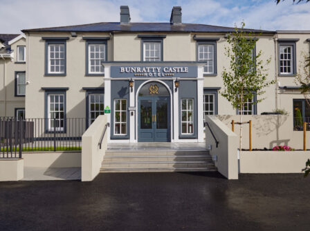 Charming Bunratty Castle Hotel front with elegant facade, inviting entrance, and lush greenery. Perfect for tranquil stays.