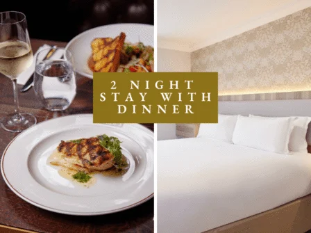 Elegant hotel room with king-size bed and gourmet dining with wine, perfect for a relaxing two-night stay.