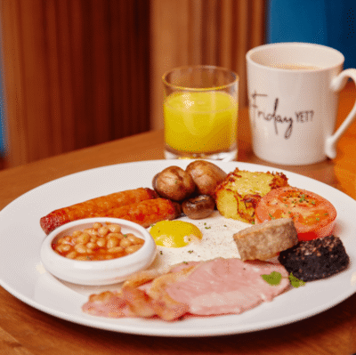 Enjoy a full English breakfast with beans, eggs, sausages, bacon, mushrooms, and juice at our cosy hotel restaurant.
